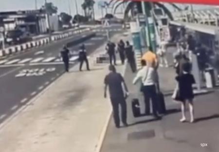 Police officers shooting a man at an airport.