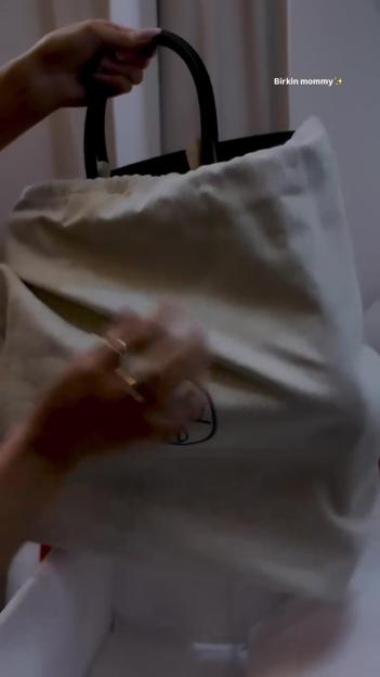 A woman unboxing a designer handbag.