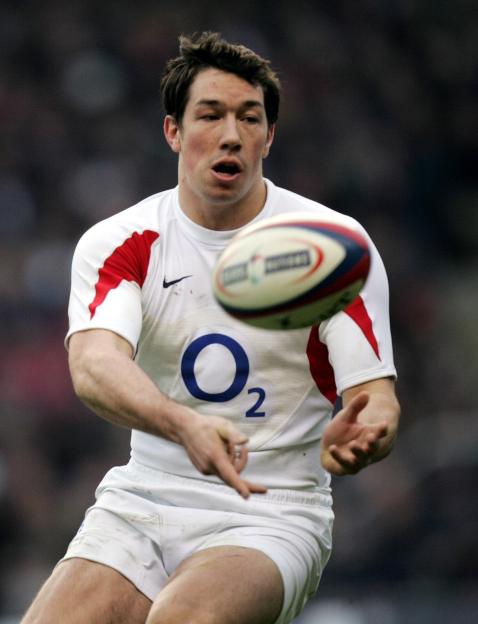 Tom Voyce, former England rugby player, throwing a rugby ball.
