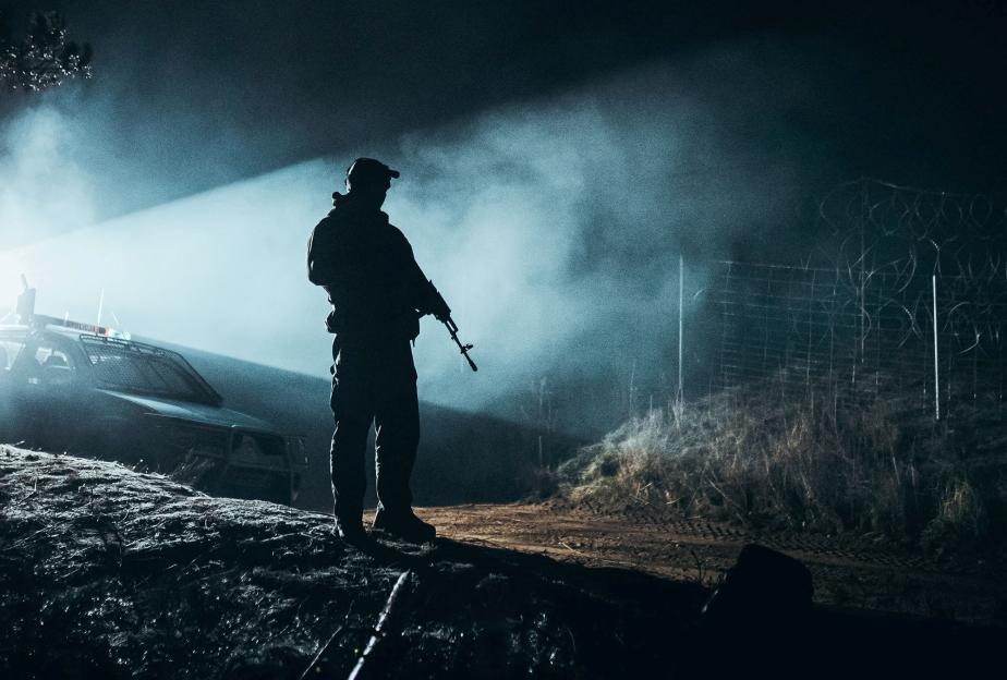 A Polish soldier patrolling the Poland-Belarus border at night.