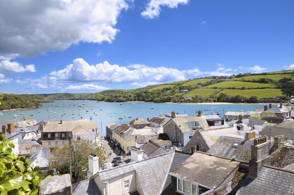 View of Salcombe, Devon, showing boats in the estuary and rooftops of the town.