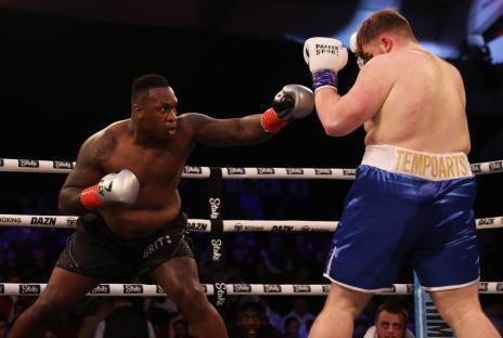 TELFORD, ENGLAND - MARCH 04: Godson Umeh punches Tempo Arts during the heavyweight match between Tempo Artsand Godson Umeh at Telford International Centre on March 04, 2023 in Telford, England. (Photo by Nathan Stirk/Getty Images)