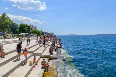 The Sea Organ in Zadar, Croatia, with many people sitting on the steps.