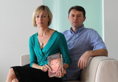 Parents of Madeleine McCann holding up their daughter's pajamas at a press conference.
