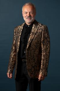 Graham Norton in a gold brocade jacket.