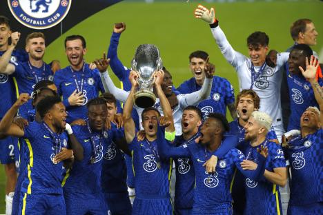 Chelsea players celebrating with the European Super Cup trophy.