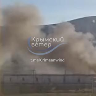 Smoke billowing from burning warehouses following a Ukrainian attack.