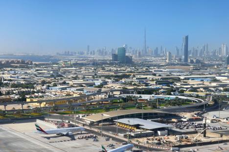 Aerial view of Dubai International Airport and the city skyline.