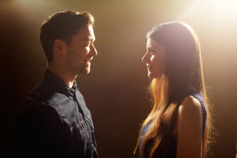 Young couple facing each other.