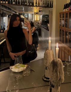 Mirror selfie of a woman in a Barcelona wine bar.