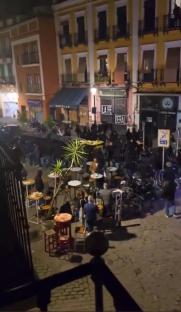 Real Betis and Fiorentina fans clashing in a city square.