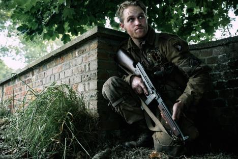 Wyatt Russell as Ford in *Overlord*, holding a rifle.