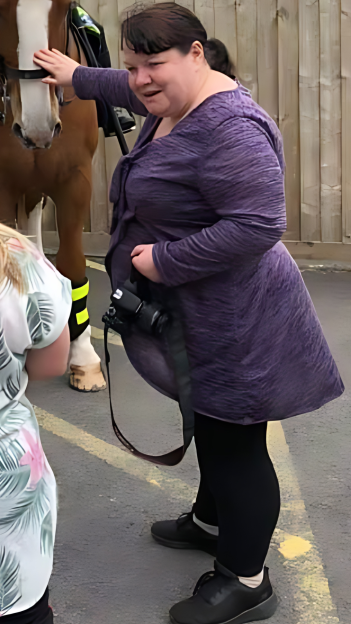 Woman petting a horse.
