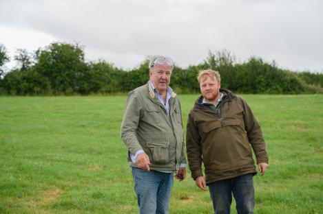 Jeremy Clarkson and Kaleb Cooper standing in a field.