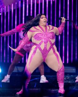 Lizzo performing on stage.