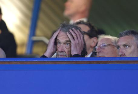Sir Jim Ratcliffe looking disappointed at a sporting event.