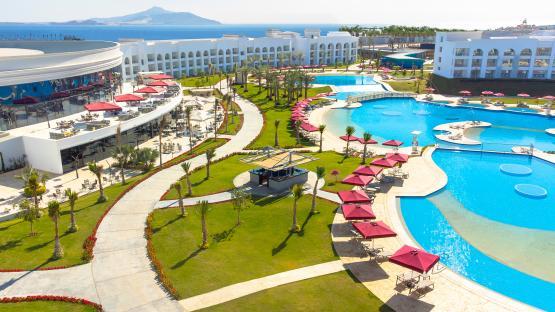 Aerial view of Rixos Radamis resort with pools and palm trees.