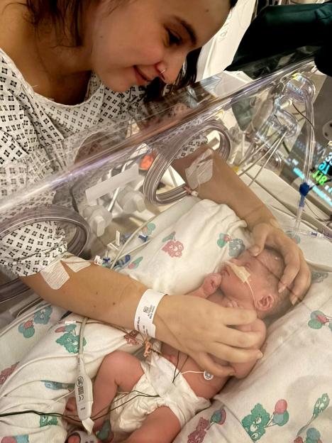 Megan Isherwood looking at her baby Jackson in the hospital.