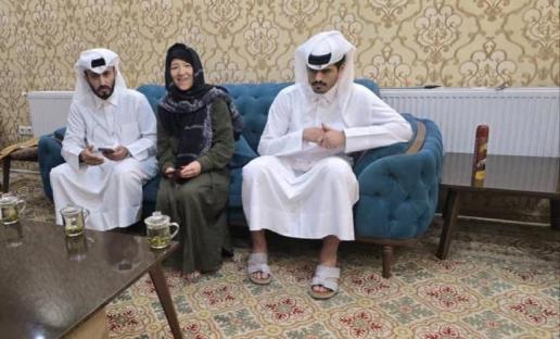 Three people sitting on a couch.
