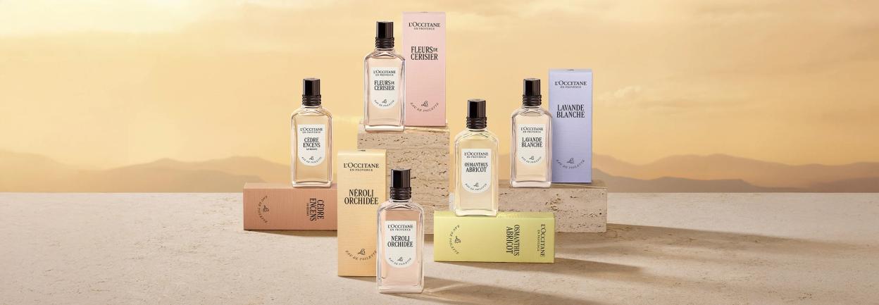 Various L'OCCITANE perfumes and their boxes, including Fleurs de Cerisier, Cèdre Encens, Néroli Orchidée, Osmanthus Abricot, and Lavande Blanche.