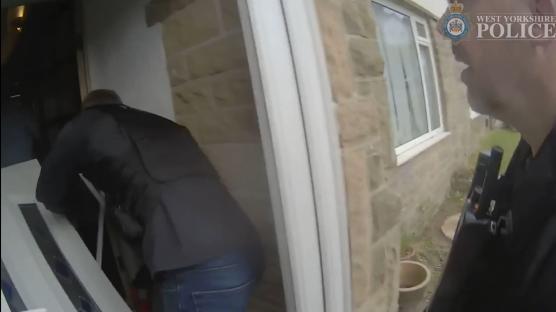 Police officers raiding a house during a County Lines drug bust.