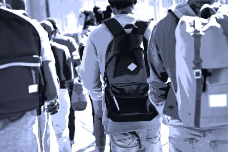 Illustration of students with backpacks walking away from the camera.