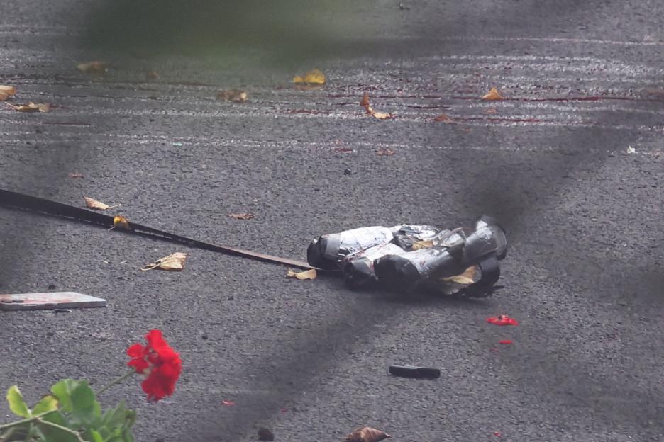 The body of a man, believed to be an attacker, lies on the ground after a car and stabbing attack outside a synagogue.