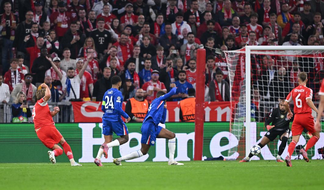 Bayern Munich's Harry Kane scores a goal past Chelsea's Robert Sanchez.