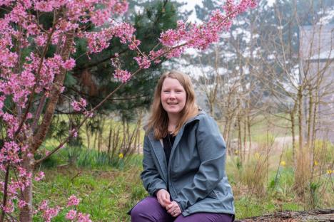 Dr. Hayley Jones, Principal Entomologist, sitting in a garden.