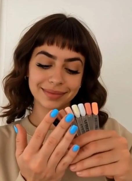 Woman showing off nail polish swatches.