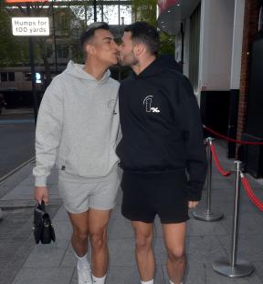Two men kissing outside Ministry of Sound.