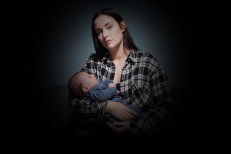 Jacqueline Jossa as Lauren Branning in EastEnders holding a baby.