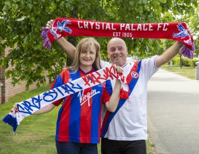 Crystal Palace fans holding scarves.
