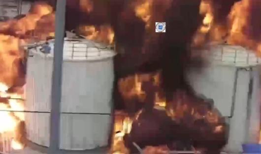 Large containers engulfed in flames.
