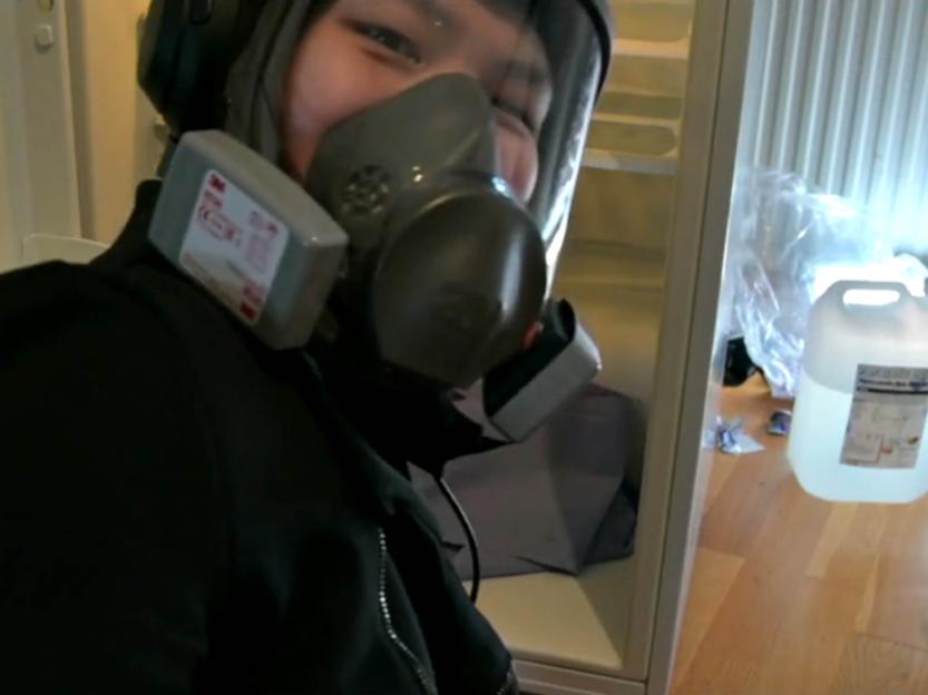 Handout still image of Scarlet Blake wearing a respirator mask.