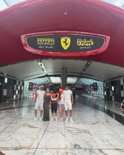 Family posing at the entrance to Ferrari World Abu Dhabi.