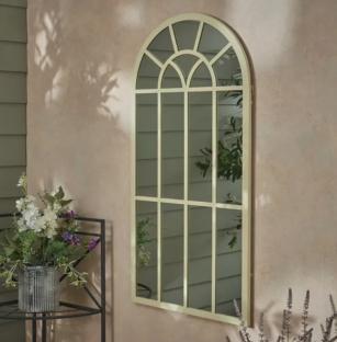 Arch-shaped garden mirror with a paneled design.