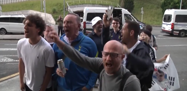 A crowd of jubilant soccer fans celebrating.