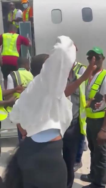 Moment plane passenger bundled screaming onto airport bus after punching stewardess & ‘refusing to turn off her phone’
