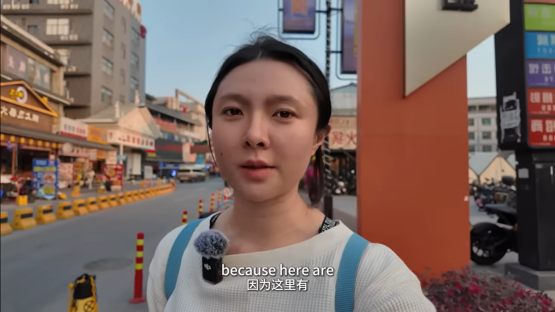Woman speaking outside a building in a city.
