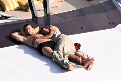 Maya Jama and Ruben Dias cuddling on a yacht.