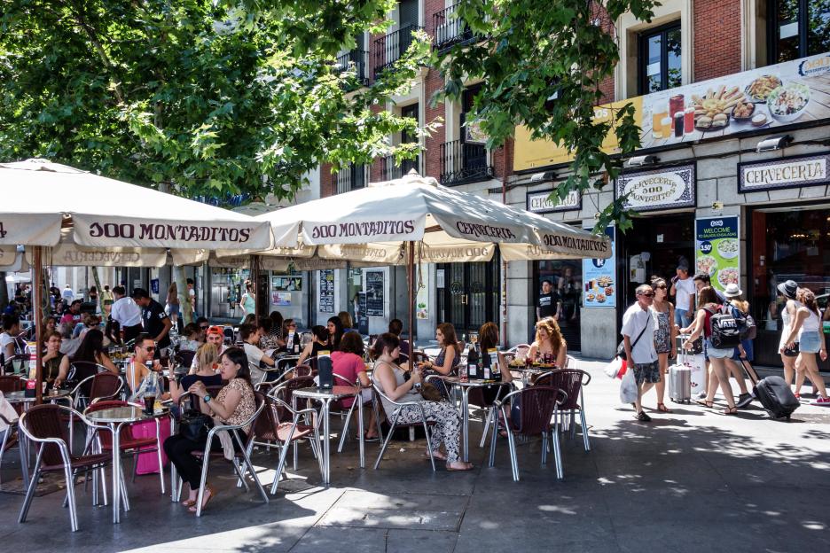 Patrons sitting outside a Cerveceria 300 Montaditos cafe in Seville.