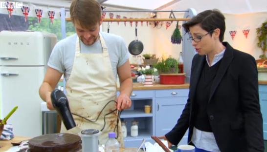 John Whaite on the Great British Bake Off using a hairdryer on a cake.