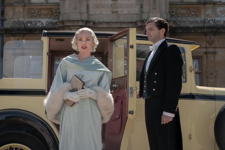 Still image from Downton Abbey: A New Era showing Laura Haddock and Michael Fox in period costume.