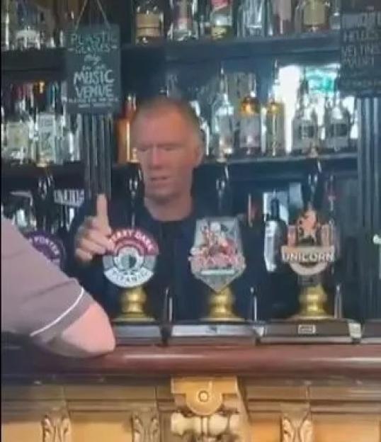 Paul Scholes pouring pints in a pub.