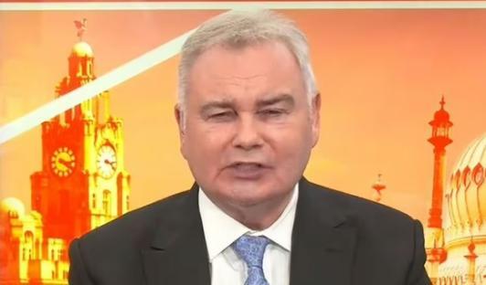 Two men in suits sitting at a table discussing reform on a news program.