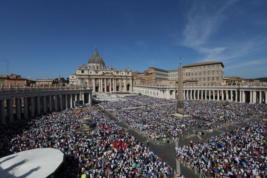 Large crowd gathered in St. Peter's Square for a Eucharistic celebration.