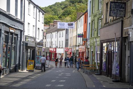 Bangor high street with many mobile repair shops and empty commercial properties.