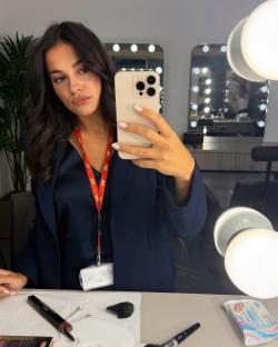 Woman taking a selfie in a makeup room.