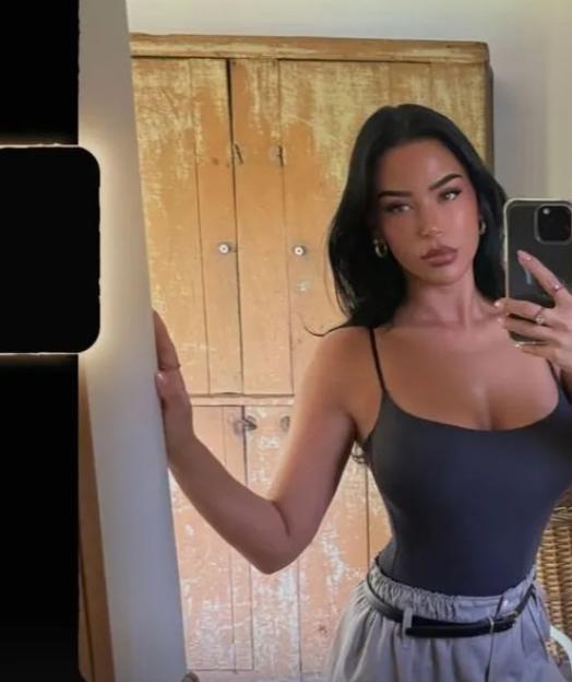 Selfie of a woman in a black bodysuit.